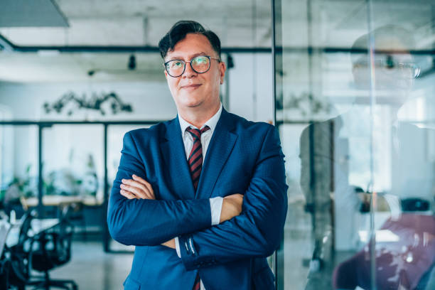 Shot of a handsome mature businessman with arms crossed posing in the work place